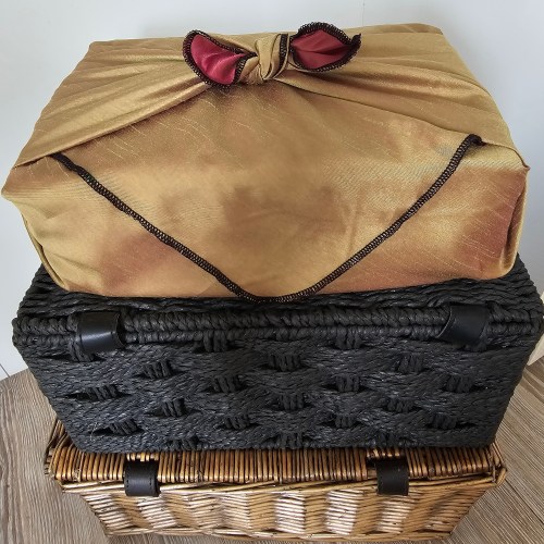 Green_silk_burgundy_satin_fabric_gift_wrapping_tied_around_a_rectangular_shaped_gift